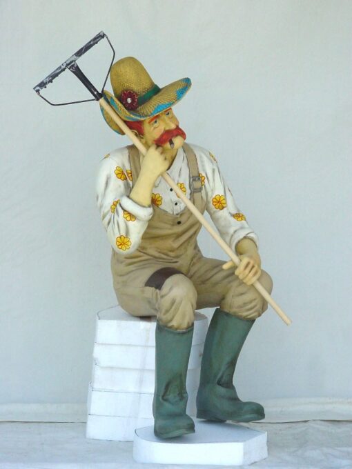 MALE GARDENER SITTING WITH RAKE JR 1611